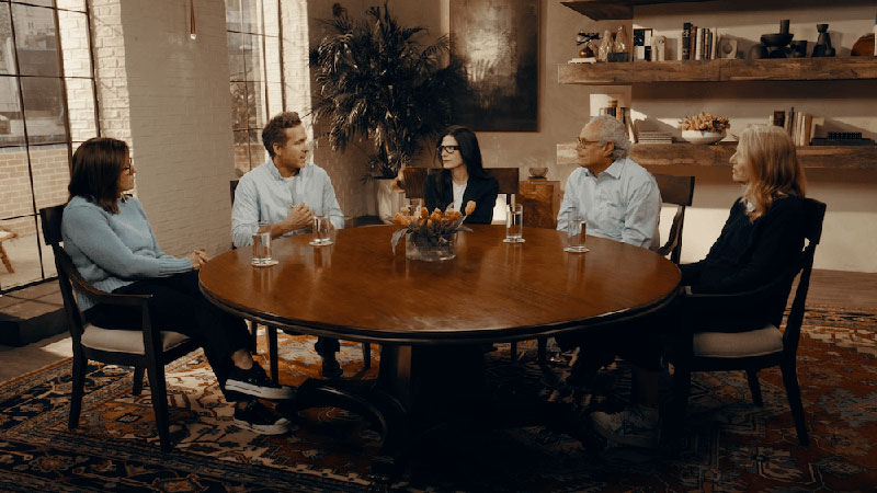 Video play button with image of Ryan Reynolds talking with Parkinson’s advocates