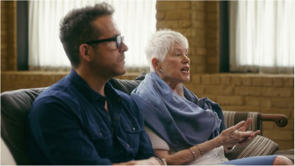 Video play button with a side profile of Ryan Reynolds and his mother talking