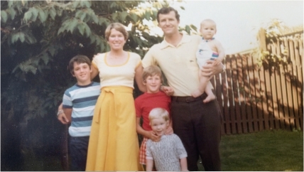Video play button with image of Ryan Reynolds when he was young with his family
