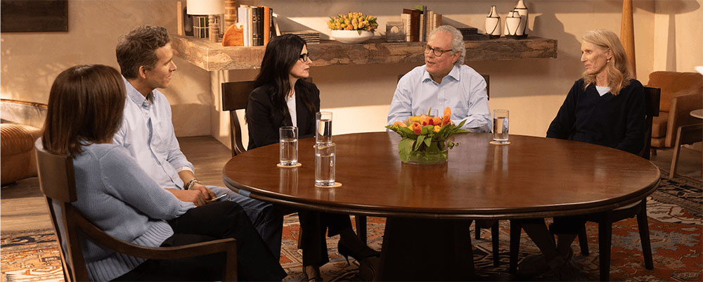 Ryan Reynolds at round table listening to someone living with Parkinson's share his story